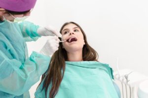 Young woman at dentist - emergency dentist